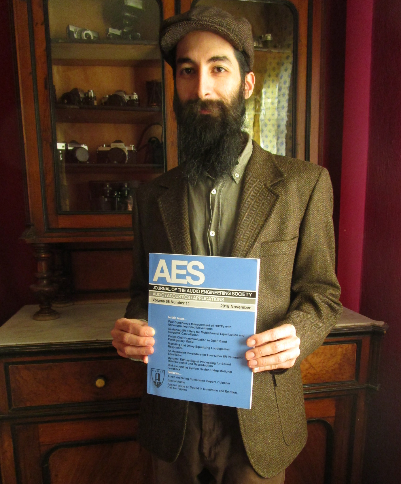 J. I. Agnew holding the AES Journal